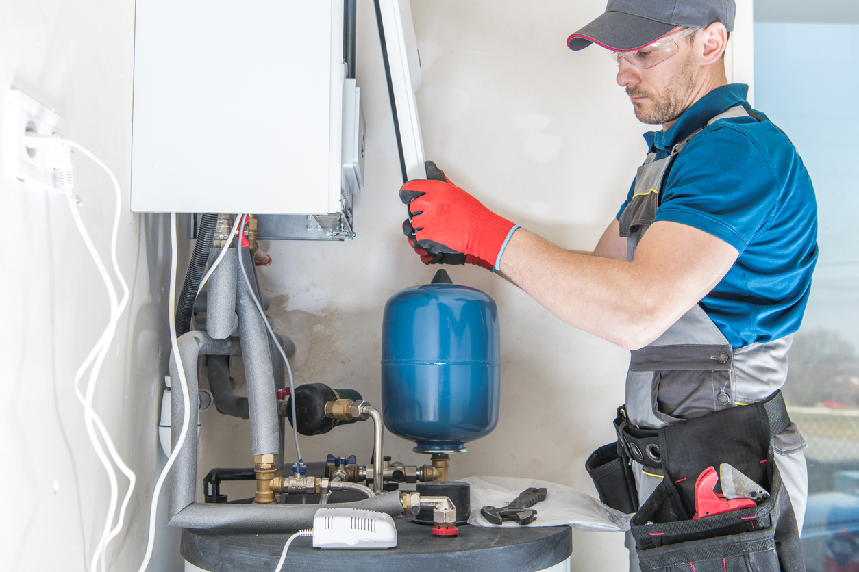 HVAC professional installing a new gas heating system in a home