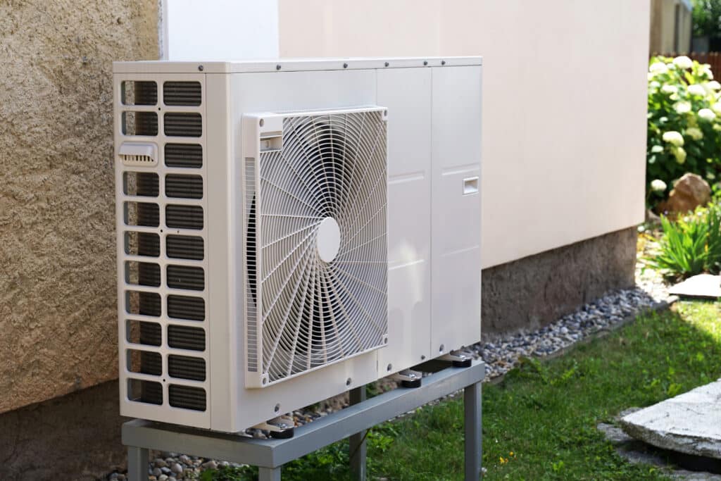 Heat pump mounted on the wall of a Northeast Indiana home