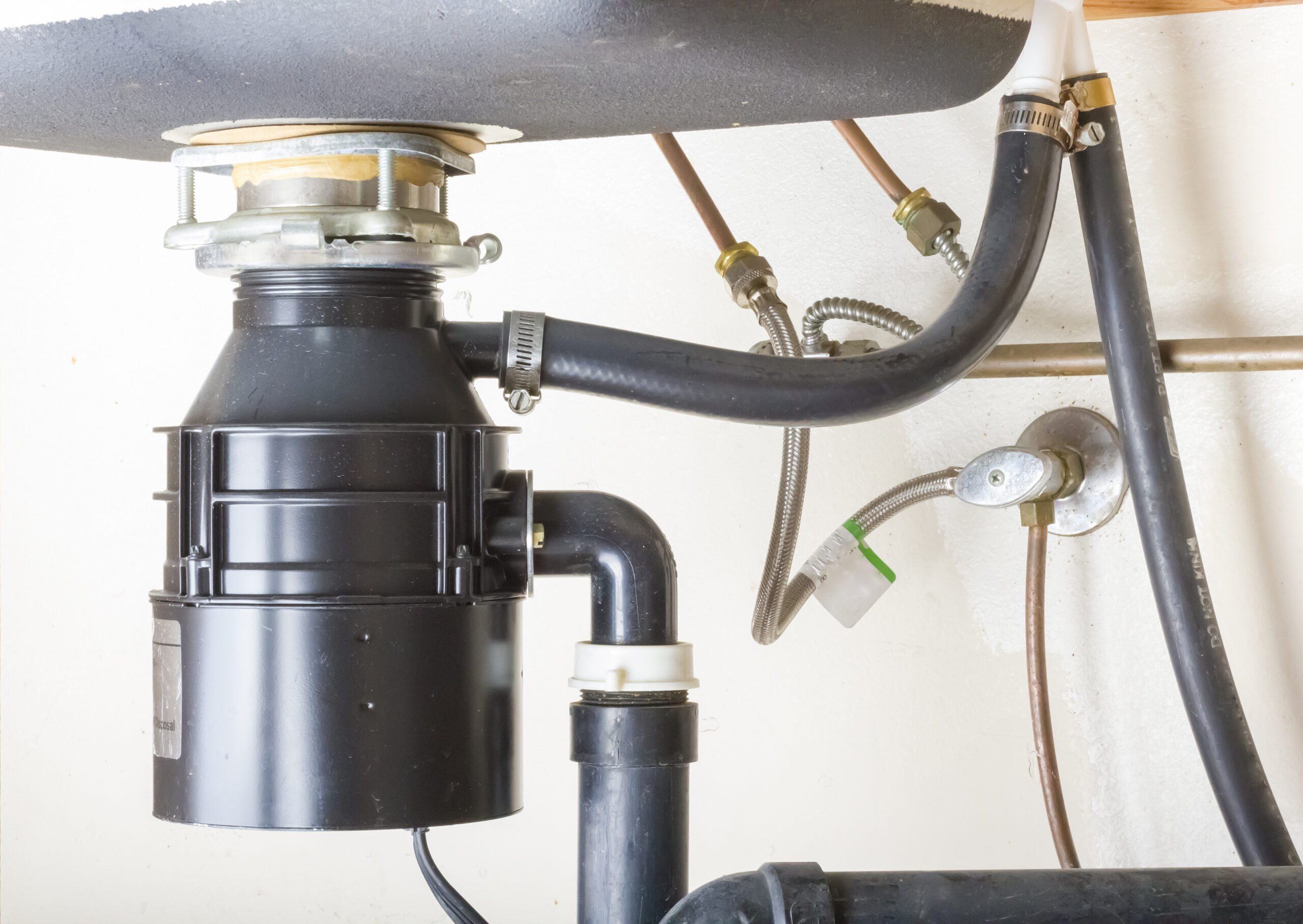 A garbage disposal installed under the kitchen sink