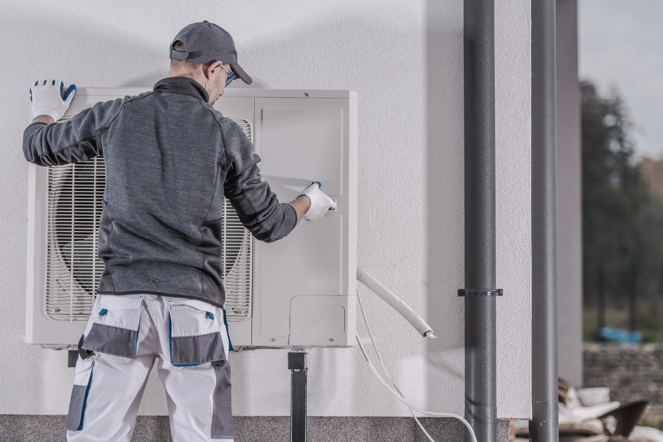 Technician repairs a residential heat pump