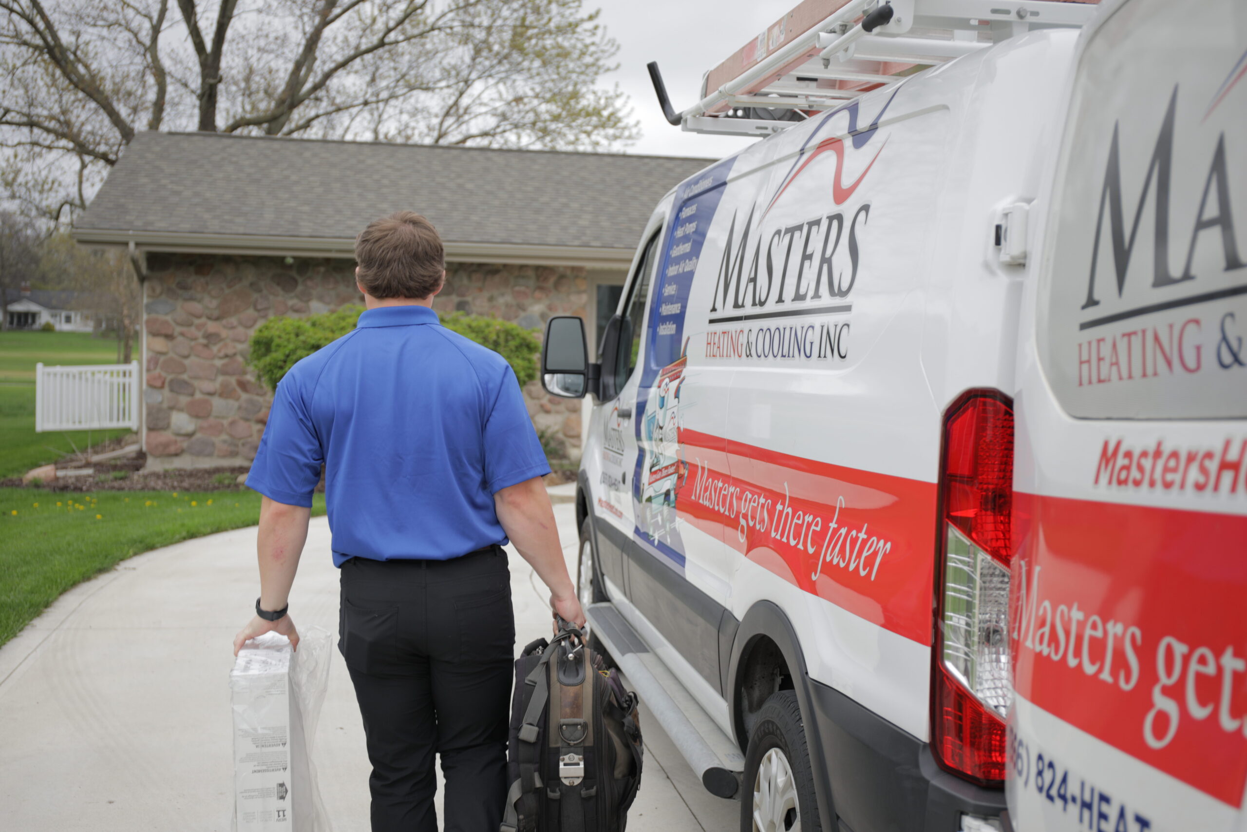 Masters Heating & Cooling Indianapolis technician replacing a furnace air filter