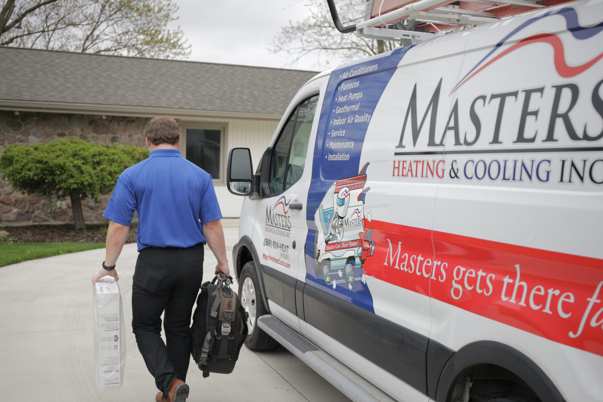 Masters Heating & Cooling technician servicing a home's ductless AC