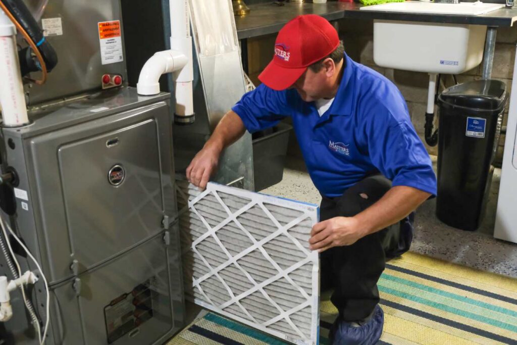 Masters Tech installing new air filter