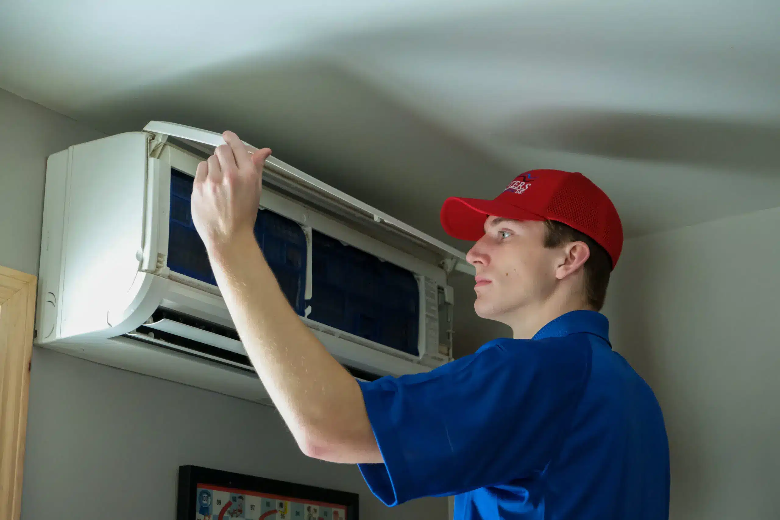 Masters Heating & Cooling technician repairing a ductless HVAC unit