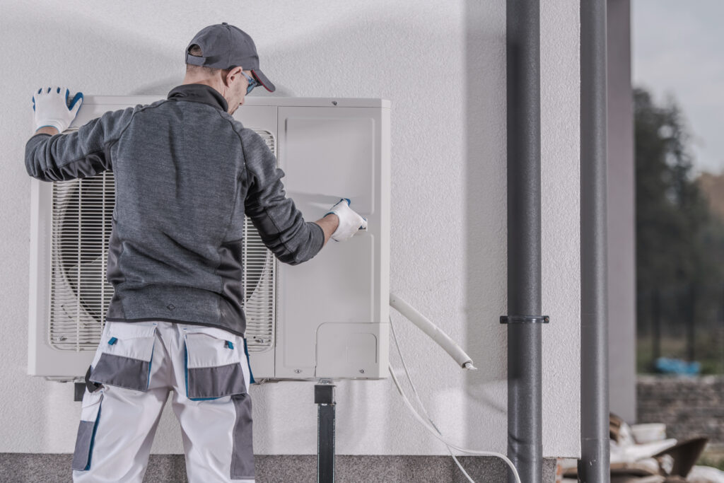 Technician installs heat pump